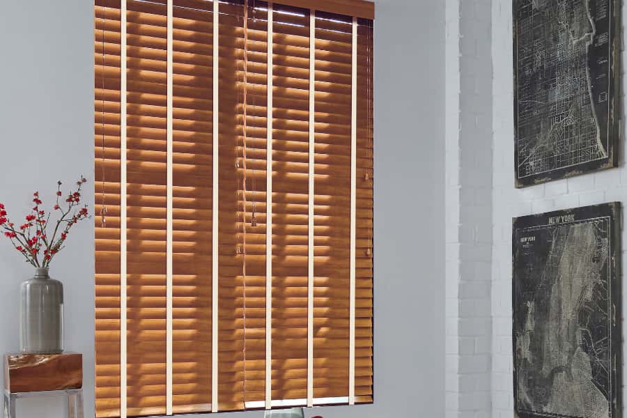 Wood blinds in a small dining room area.